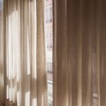 Beige curtains in the bedroom of a house